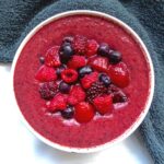 thick smoothie bowl topped with berries