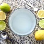 aerial view of electrolyte drink surrounded by lemons and limes
