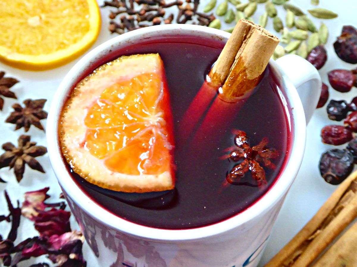 mulled tea served in mug with orange slice cinnamon stick and star anise